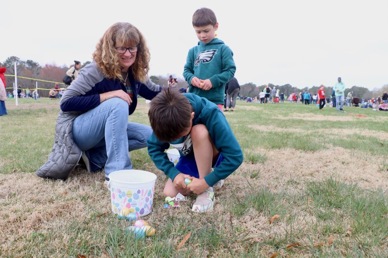 Mona Duwell, left, watches grandsons Ren and Haru count their Easter eggs after the hunt.